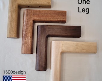 May include: Four wooden furniture legs in varying shades of brown and tan. The legs are L-shaped, with a rectangular post and a horizontal piece. The text "One Leg" is visible, along with the "1600design" logo and an American flag.