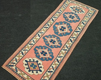 May include: A pink and blue runner rug with a geometric pattern. The rug has a traditional design with repeating motifs.