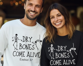 May include: A white and a black sweatshirt with the text "DRY BONES COME ALIVE" and the Bible verse Ezekiel 37. The design includes dancing skeleton figures. The sweatshirts are perfect for Halloween or a spooky theme.