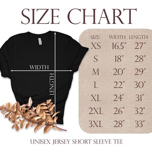 May include: A black unisex jersey short sleeve tee shirt with a size chart. The chart shows measurements for sizes XS to 3XL, with widths ranging from 16.5 inches to 28 inches and lengths from 27 inches to 33 inches.