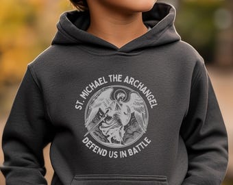 May include: A dark gray hooded sweatshirt with a white graphic print of an angel with wings and a sword. The text around the angel reads "St. Michael the Archangel Defend Us In Battle".