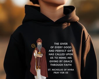 May include: Black hoodie with a white illustration of Saint Nicholas holding a bag of gifts. The text reads "The giver of every good and perfect gift has called upon us to mimic his giving by grace through faith. St. Nicholas of Myra pray for us."