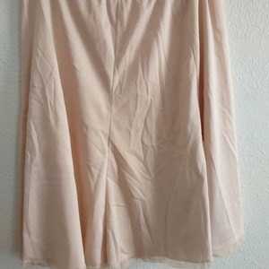 Vintage women&#39;s pink half slip with lace waist and hem