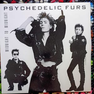 May include: Black and white album cover for the band Psychedelic Furs. The album is titled "Midnight to Midnight". The cover features three band members in black leather jackets and pants. The band members are in various poses.
