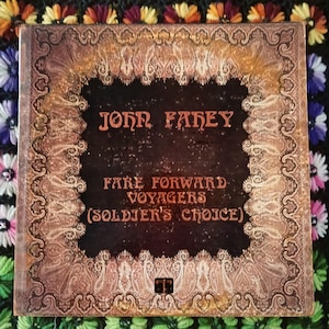 May include: A vintage vinyl record album cover with the text "JOHN FAHEY" and "FARE FORWARD VOYAGERS (SOLDIER'S CHOICE)". The cover has a dark brown background with ornate gold and brown paisley-style borders.