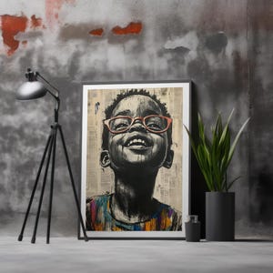 Op de afbeelding: Zwart-wit ingelijste kunstdruk van een lachend kind met een rode bril. Het kind kijkt omhoog met een vrolijke uitdrukking. De achtergrond is een collage van krantenknipsels. Het kind draagt een kleurrijk shirt.