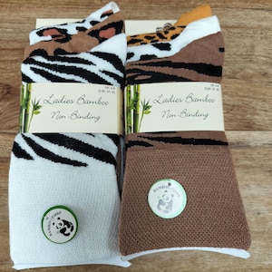 May include: A white ceramic mug with a black handle and the text "But First, Coffee" in a handwritten style. The mug is on a white surface. The mug is approximately 4 inches tall.