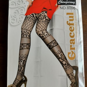 Può includere: Collant neri a fantasia con un complesso design in pizzo e rete. La confezione riporta il testo Chengxiang NO.8096 e la parola Graceful. I collant sono mostrati indossati con una gonna rossa e scarpe con tacco alto sulla scatola.