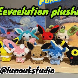 May include: A collection of handmade crochet Eeveelution plushies in various colors, including yellow, pink, blue, and black. The plushies are displayed on a wooden shelf, with the text "Eeveelution plushies" in green.