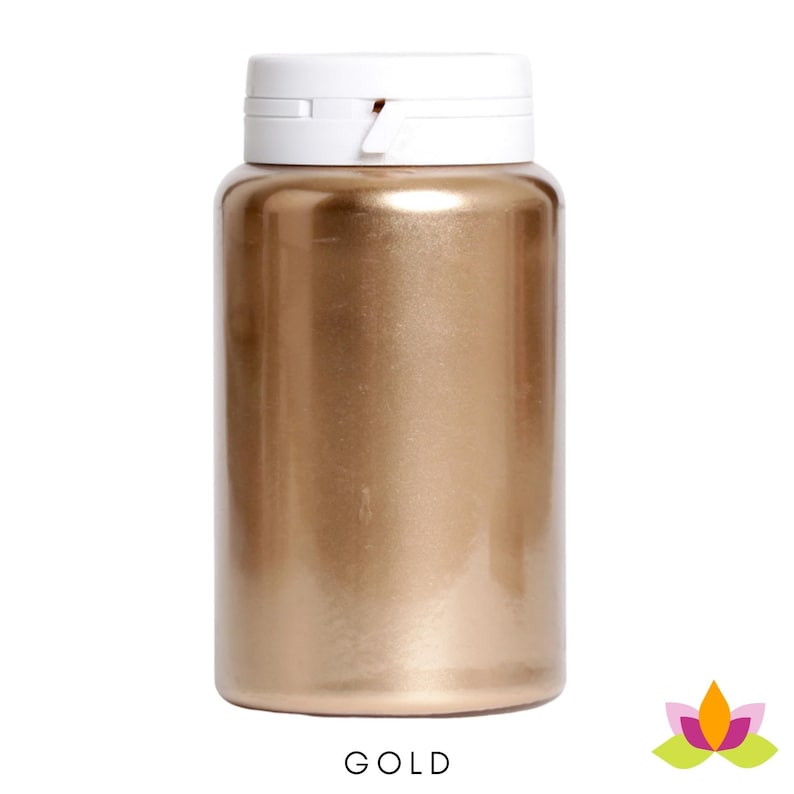 May include: A gold colored bottle of edible luster dust. The bottle has a white lid with a flip top.