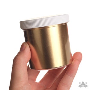 May include: A gold metallic paint in a white plastic jar with a screw-on lid.