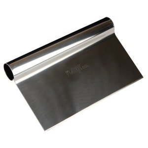 May include: A stainless steel bench scraper with a rolled handle. The scraper has a rectangular blade and is designed for cutting and scraping dough or other ingredients. The brand name "FONIX CEL" is etched on the blade.