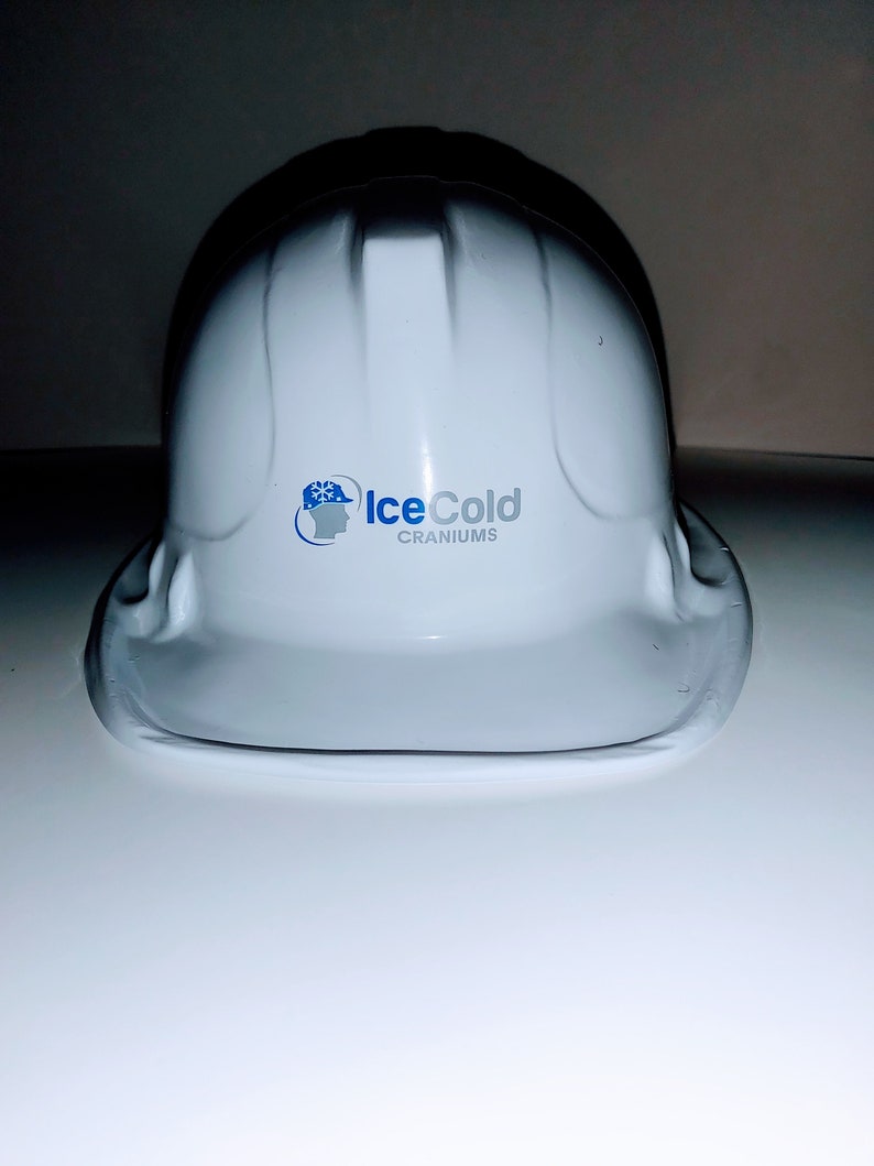 May include: White hard hat with a blue and white logo that says "IceCold Craniums".
