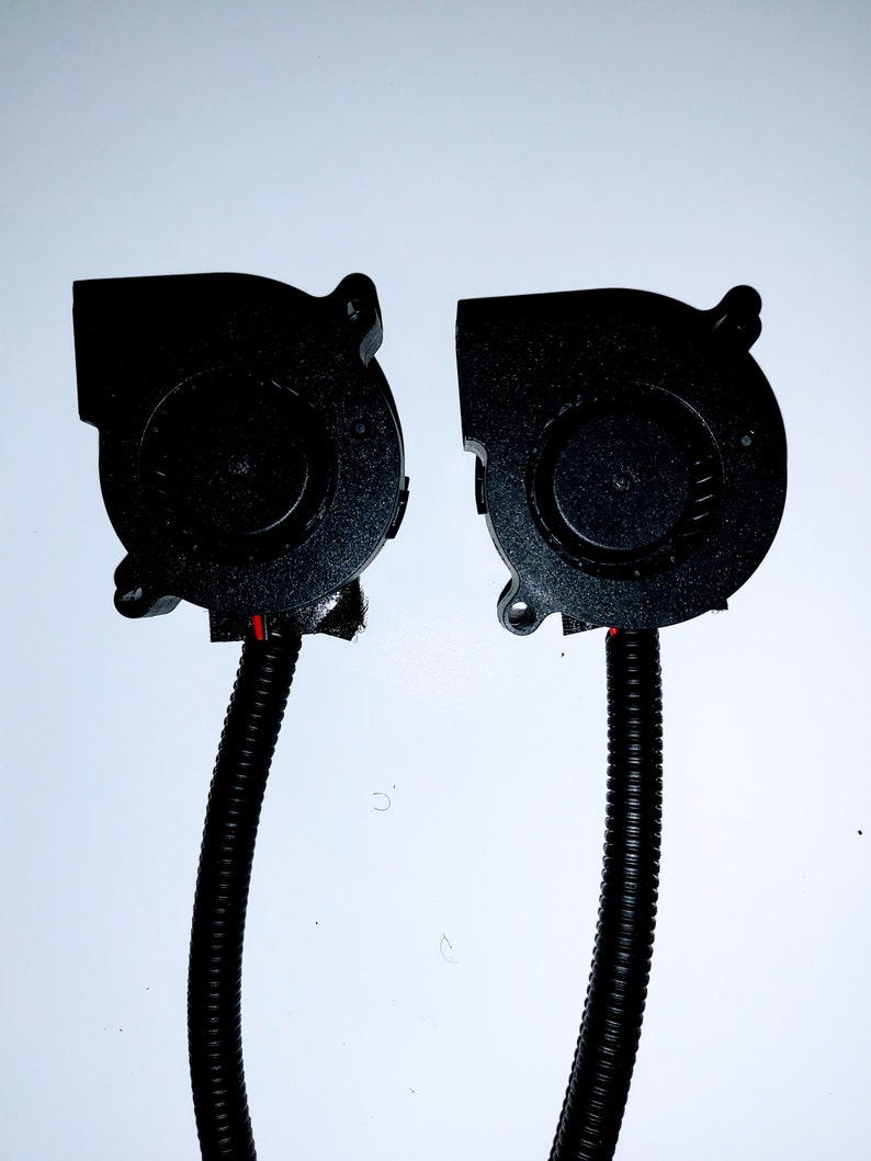 May include: Two black computer cooling fans with black wires attached. The fans have a black plastic housing and a black impeller.