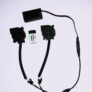 May include: Two black cooling fans with black wires and connectors, a black battery pack, and a 6.50 mAh Doublepower battery.