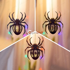 May include: Three black spider-shaped Halloween decorations with intricate cut-out designs. Each spider has a light inside and hangs from a string.