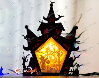 May include: A black papercraft Halloween haunted house with a light inside. The house has a pointed roof, windows, and a door. There are bats and trees around the house.