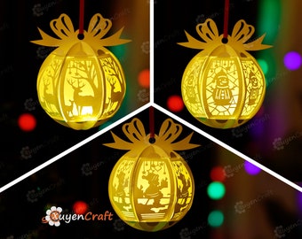 May include: Three yellow paper Christmas ornaments with intricate cut-out designs. The ornaments feature a deer, a snowman, and a couple ice skating.