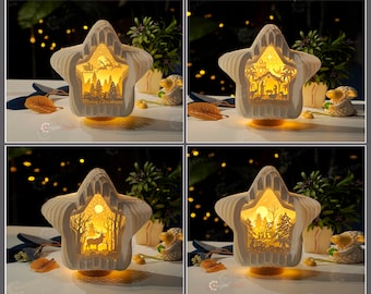 May include: Four white star-shaped paper light-up Christmas decorations with different scenes inside. The scenes include a Christmas tree, a nativity scene, a winter forest, and a winter village.
