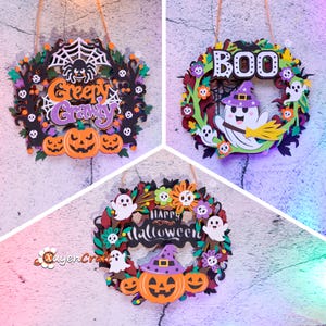 May include: Three circular Halloween wall hangings featuring layered cutouts. One displays a spider, web, and pumpkins with the text Creepy Crawly. Another shows a ghost with a broom and the text BOO. The third features ghosts, flowers, and a pumpkin with the text Happy Halloween.