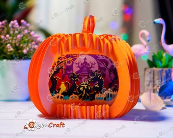 以下が含まれることがあります： オレンジ色の紙製のジャック・オ・ランタンで、中にハロウィンシーンが描かれています。シーンには、幽霊屋敷、コウモリ、墓地、満月が描かれています。