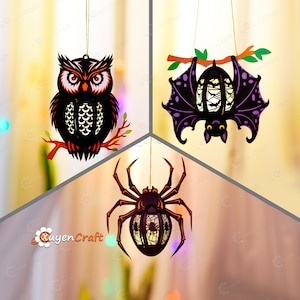 May include: Three Halloween-themed hanging decorations: a black owl, a purple bat, and a black spider. Each decoration has a cut-out design and a string for hanging.