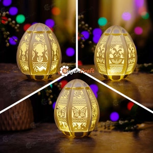 May include: Three white ceramic Easter egg-shaped night lights with intricate cut-out designs. The designs include butterflies, flowers, and geometric patterns. The lights are illuminated from within, casting a warm glow.