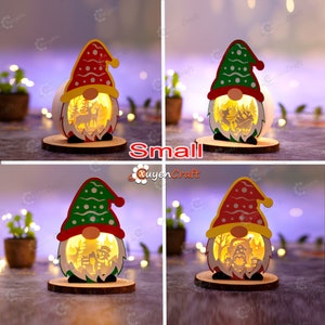 Pode incluir: Quatro pequenas decora&ccedil;&otilde;es de gnomos de madeira iluminadas com designs festivos. Cada gnomo tem um chap&eacute;u vermelho ou verde, uma barba branca e uma cena recortada no interior. Os gnomos est&atilde;o em bases de madeira, ideais para decora&ccedil;&atilde;o de festas.