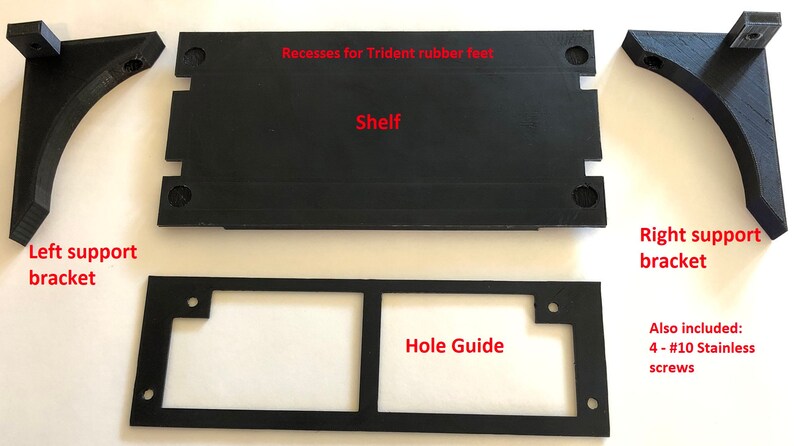 May include: A set of black 3D printed parts for a shelf, including a shelf, two support brackets, and a hole guide. The shelf has recesses for rubber feet. Also included are four #10 stainless steel screws.
