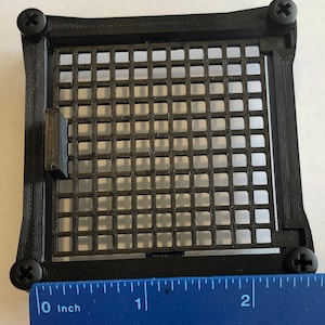 May include: Black plastic frame with a black mesh grid insert. The frame is approximately 2 inches wide.