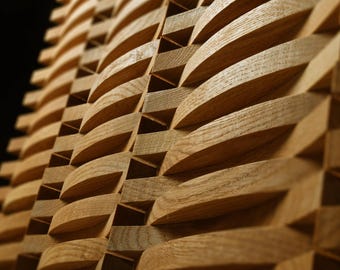 May include: A light brown wooden wall panel featuring a repeating geometric pattern of interlocking curved slats. The structure consists of horizontal and vertical pieces of natural wood grain, creating a textured, three-dimensional surface with deep shadows.