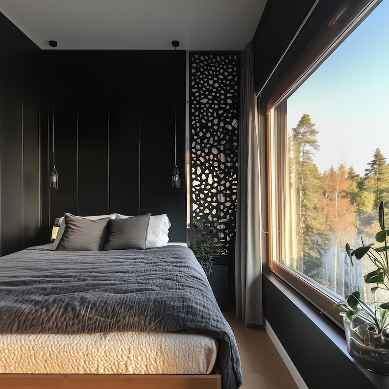 Modern bedroom with black accent wall, geometric room divider, and floor-to-ceiling windows overlooking greenery.