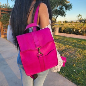 Pink leather backpack for women with a gifted clutch.