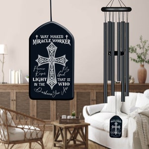 May include: Black wind chime with a cross and the words "Way Maker Miracle Worker" on a black tag. The tag also says "Promise Keeper My God That Is Who In The Darkness You Are".