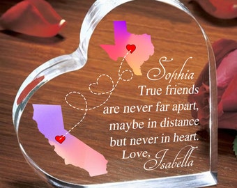 May include: A clear, heart-shaped glass keepsake with a map of Texas and California, each with a heart marking a location. The text reads "Sophia, True friends are never far apart, maybe in distance but never in heart. Love, Isabella."
