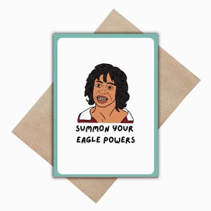 May include: Greeting card with a cartoon illustration of a person with dark hair and the text "SUMMON YOUR EAGLE POWERS" in black. The card has a teal border and is on a brown envelope.