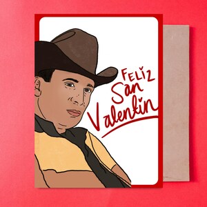 May include: Valentine's Day card featuring a cartoon illustration of a man in a cowboy hat. The card has a red border and the words "Feliz San Valentin" in red script. The card is paired with a brown envelope.