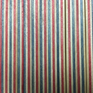 May include: Close-up of a wooden surface with alternating red, blue, and natural wood stripes. The wood is stained and has a slightly distressed look.
