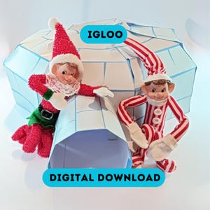 May include: Two elf figurines in red and white outfits with a white lace collar and hat, posed near a blue and white igloo. The image includes the text "IGLOO" and "DIGITAL DOWNLOAD" in a blue rectangle.