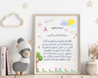 May include: A framed print with a light green background and a white cloud with a smiling sun. The print features the Arabic text of Ayatul Kursi, a verse from the Quran, in black text. The print is decorated with colorful stars, flowers, and a bird.