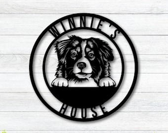 May include: Black metal sign with a dog's head peeking over the top. The sign reads "Winnie's House".