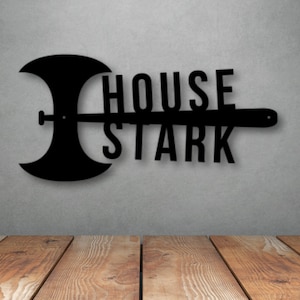 May include: Black metal wall decor featuring a stylized axe and the words "House Stark".