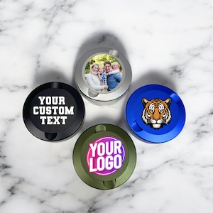 May include: Four round, metal, personalized, decorative, lidded containers. One container is silver with a photo of a family. One container is black with the text "YOUR CUSTOM TEXT". One container is blue with a tiger graphic. One container is green with the text "YOUR LOGO".