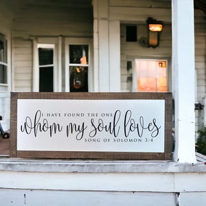 May include: A wooden sign with white background and black text that reads "I have found the one whom my soul loves Song of Solomon 3:4".