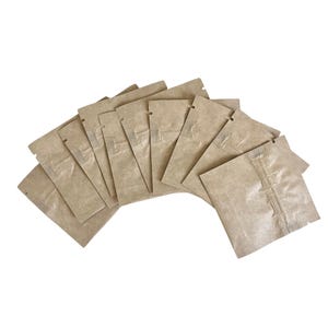 May include: A collection of small, rectangular kraft paper pouches, arranged in a fan shape. Each pouch has a zip-top closure and a textured, crinkled appearance. The pouches are a natural brown color.