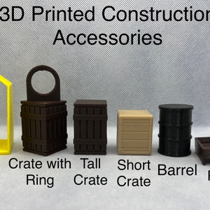 May include: 3D printed construction accessories, including a lift, a crate with a ring, a tall crate, a short crate, a barrel, and a pallet. The accessories are brown, black, and beige.