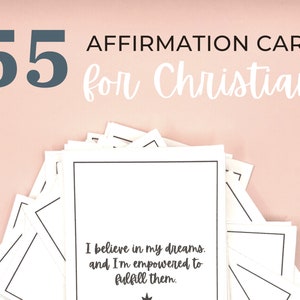 May include: A stack of 55 white affirmation cards with black borders on a pink background. The top card has the text "I believe in my dreams. and I'm empowered to fulfill them."