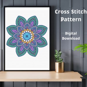 May include: A digital cross stitch pattern featuring a colorful mandala with green, purple, blue, and yellow accents. The pattern is available for digital download.