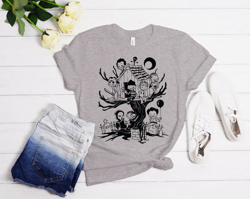 May include: A gray t-shirt with a black and white illustration of horror movie characters in a treehouse. The characters include Freddy Krueger, Jason Voorhees, Michael Myers, Leatherface, and Chucky.