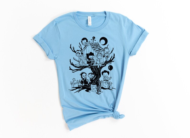 May include: Light blue t-shirt with a black graphic of horror movie characters in a treehouse. The characters include Freddy Krueger, Jason Voorhees, Michael Myers, and others.